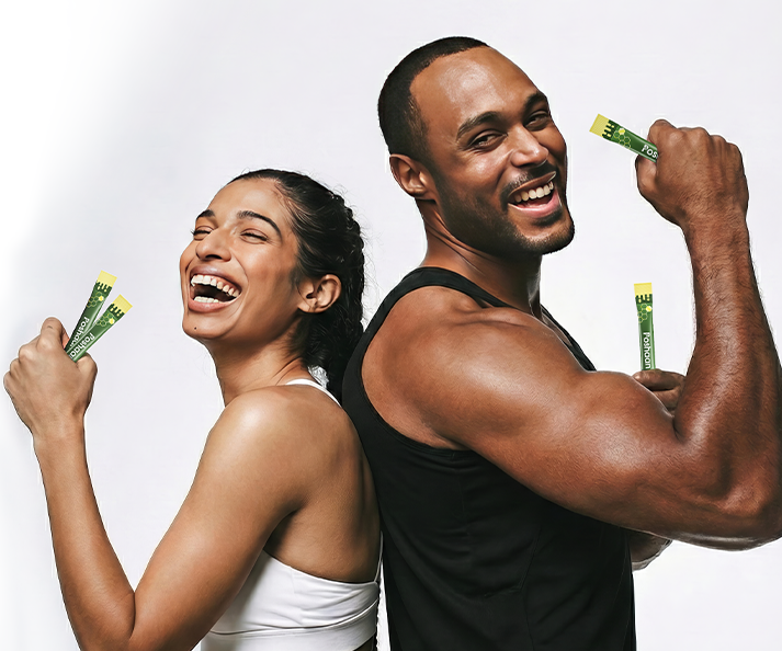 Man and woman flexing muscles with Poshaan Ashwagandha energy sticks against a white background