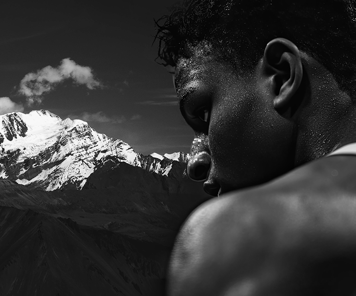Person gazing at a snow-capped mountain peak