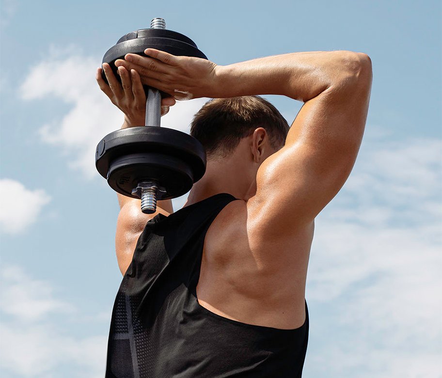 Fitness athlete lifting dumbbell outdoors with “Fuel Your Fire” motivational text promoting strength, stamina, and active lifestyle.